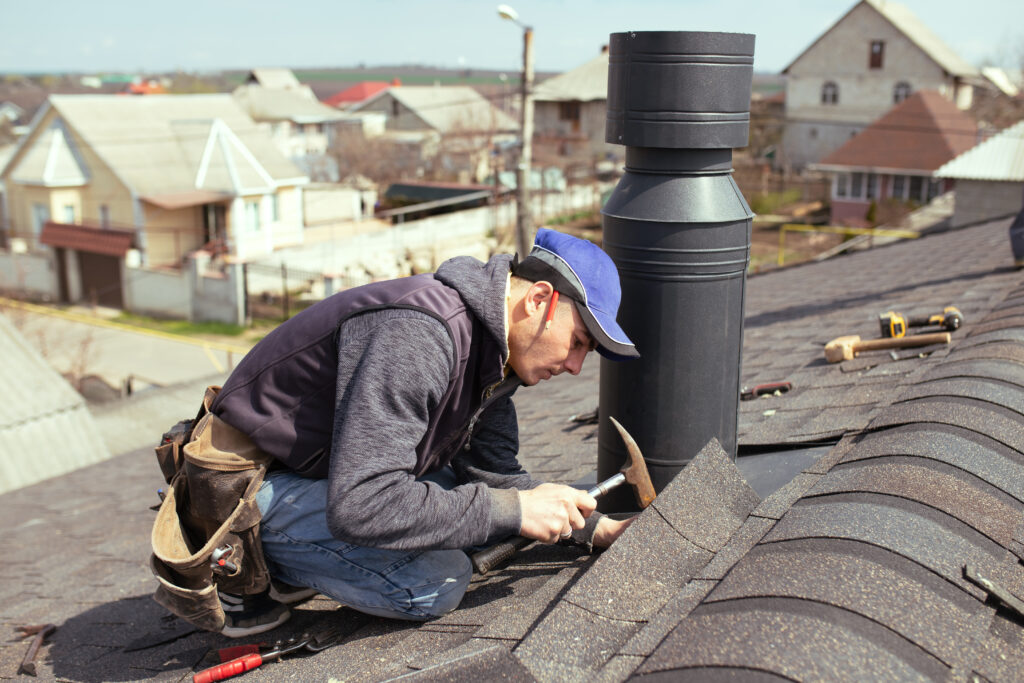 A man working on the roof of his home.